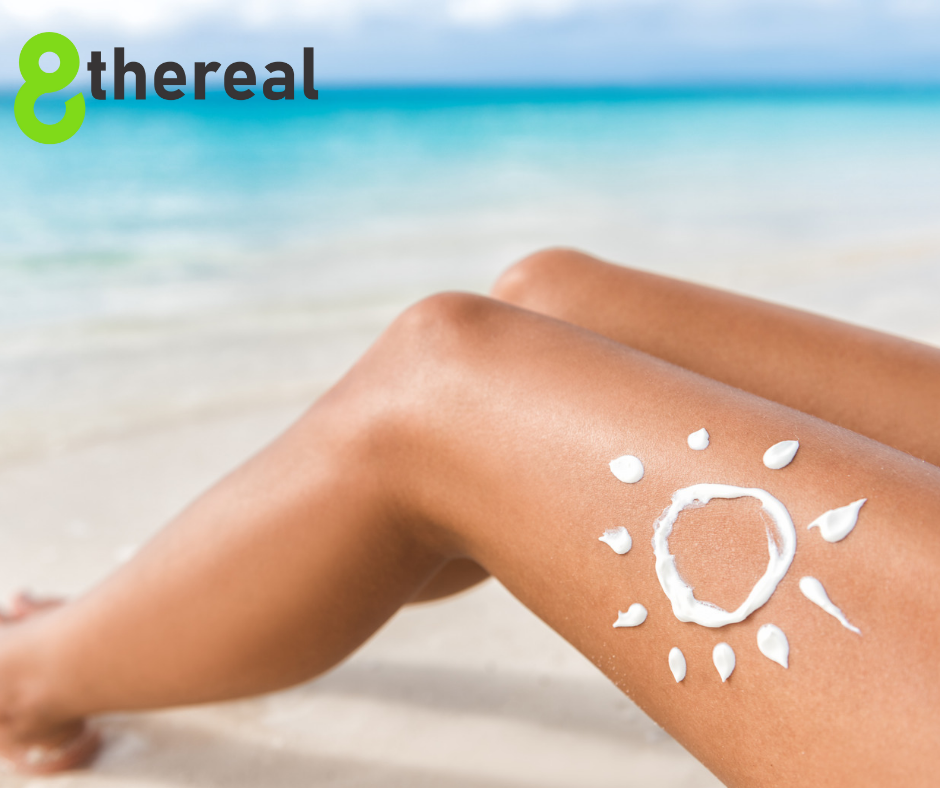 Are Tanning Drops Safe | Woman laying on white sand beach barely touching feet into water. 8thereal is seen in the top left corner. 
