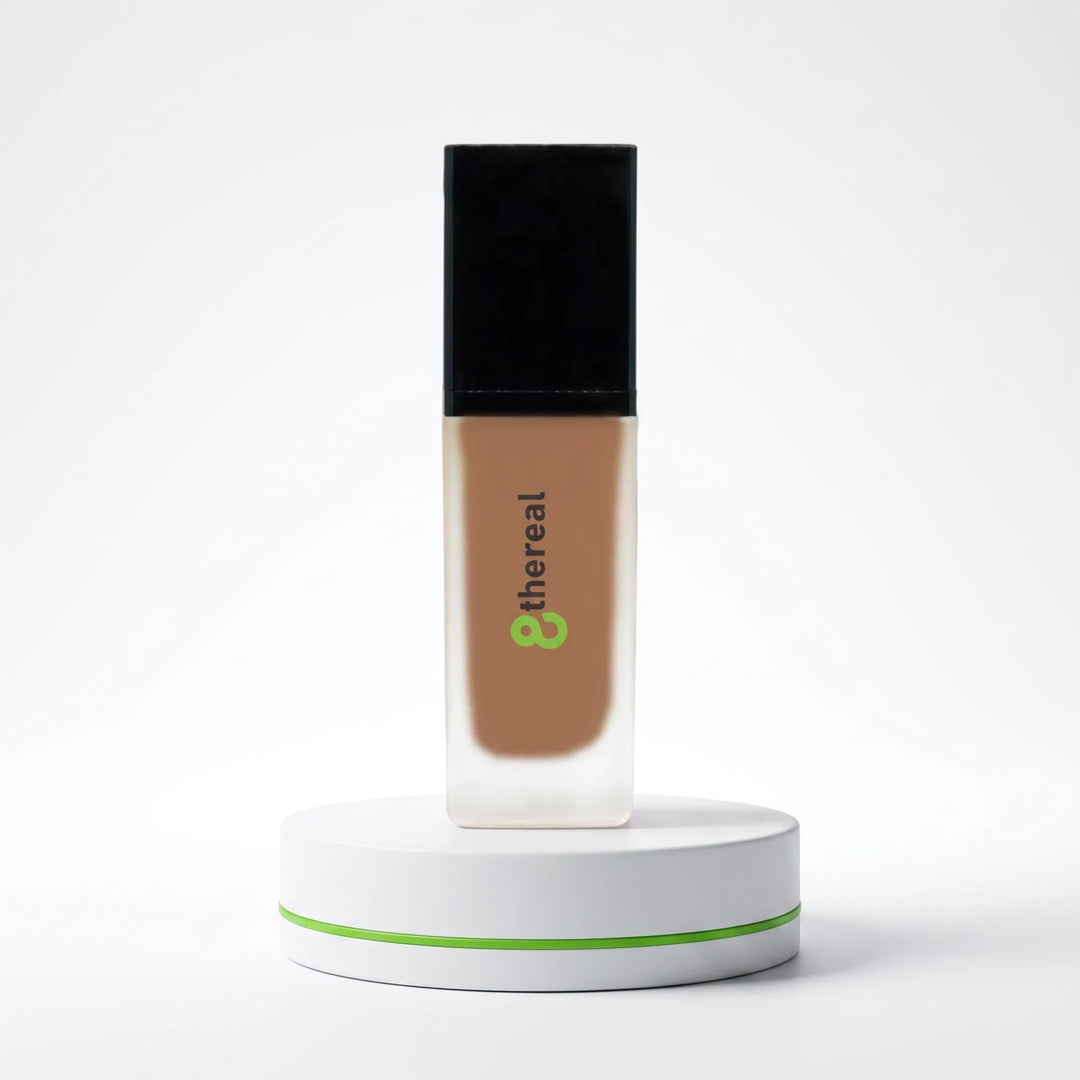 8thereal lightweight foundation with SPF in a glass bottle on a white display stand against a clean background