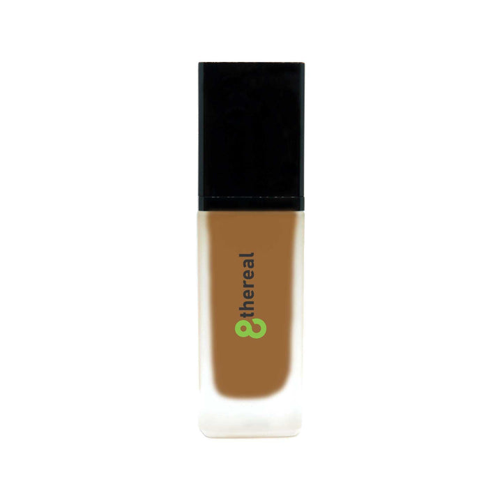 8thereal All-Day Wear Foundation SPF in a sleek glass bottle with a black cap, offering buildable coverage.