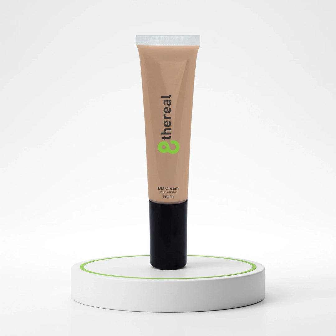 8thereal Everyday Glow BB Cream in a beige tube with a black cap, displayed upright on a white circular pedestal.