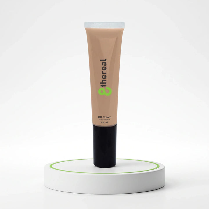 8thereal Everyday Glow BB Cream in a beige tube with a black cap, displayed upright on a white circular pedestal.