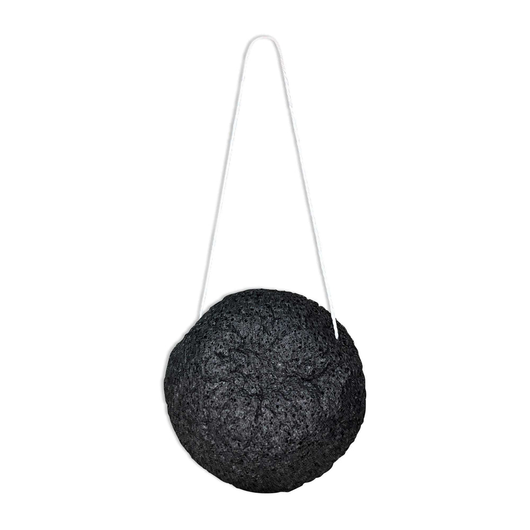 8thereal natural black konjac root fiber facial cleansing sponge with a white hanging string for easy drying