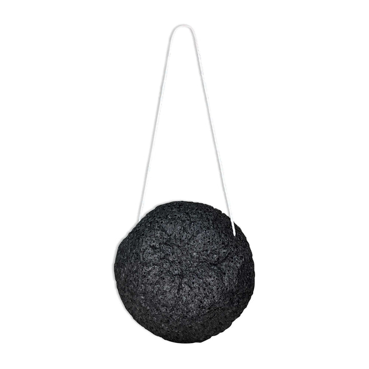 8thereal natural black konjac root fiber facial cleansing sponge with a white hanging string for easy drying
