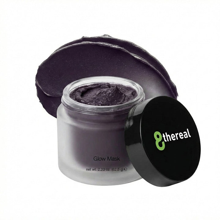 8thereal Deep-Cleansing Glow Mask in a frosted glass jar with a black lid and a smear of dark charcoal cream behind it.