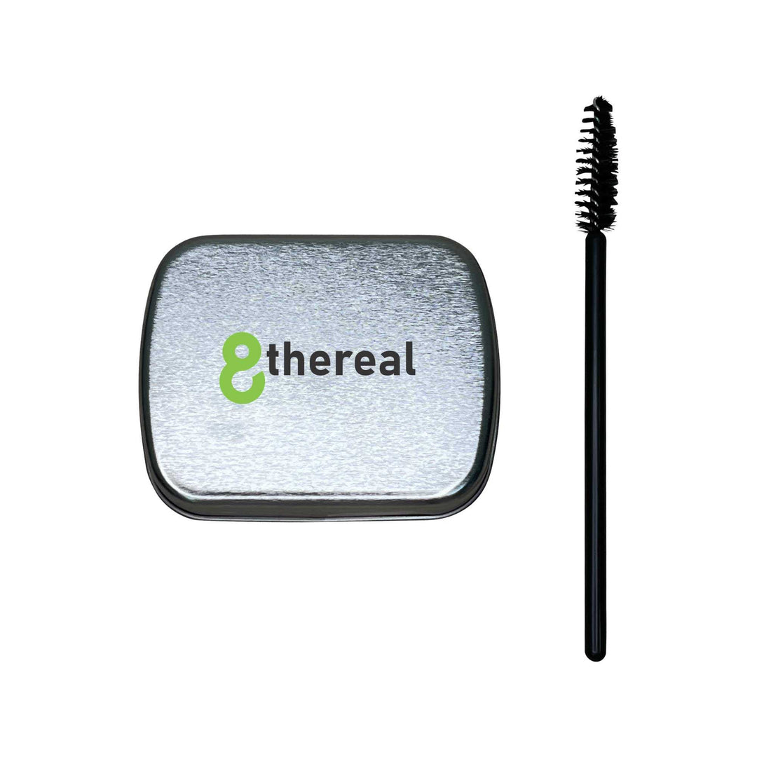 8thereal clear brow soap in a silver tin with a black spoolie brush for lifting and shaping natural eyebrows