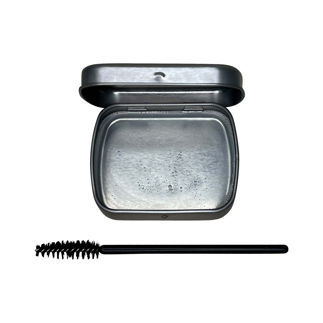 8thereal clear brow soap in a metal tin with a black spoolie brush for lifting and shaping natural eyebrows
