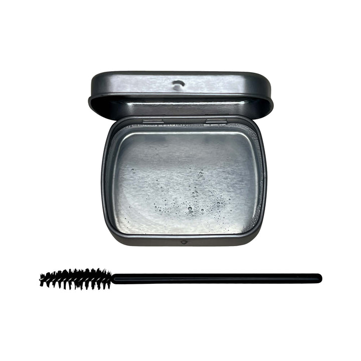 8thereal clear brow soap in a metal tin with a black spoolie brush for lifting and shaping natural eyebrows