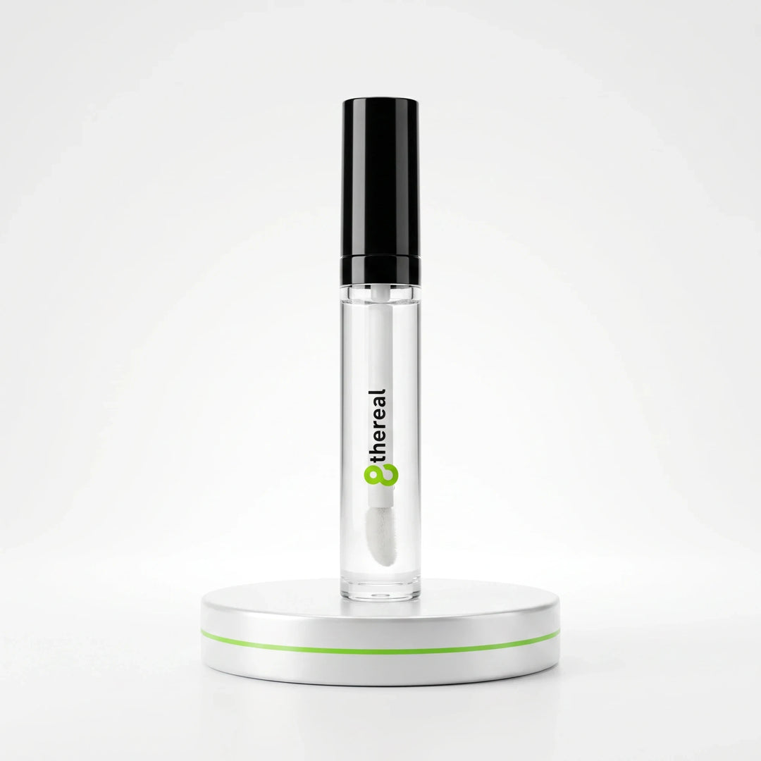 8thereal clear volumizing lip plumper gloss in a sleek tube with a black cap on a white display stand.