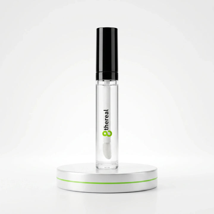 8thereal clear volumizing lip plumper gloss in a sleek tube with a black cap on a white display stand.