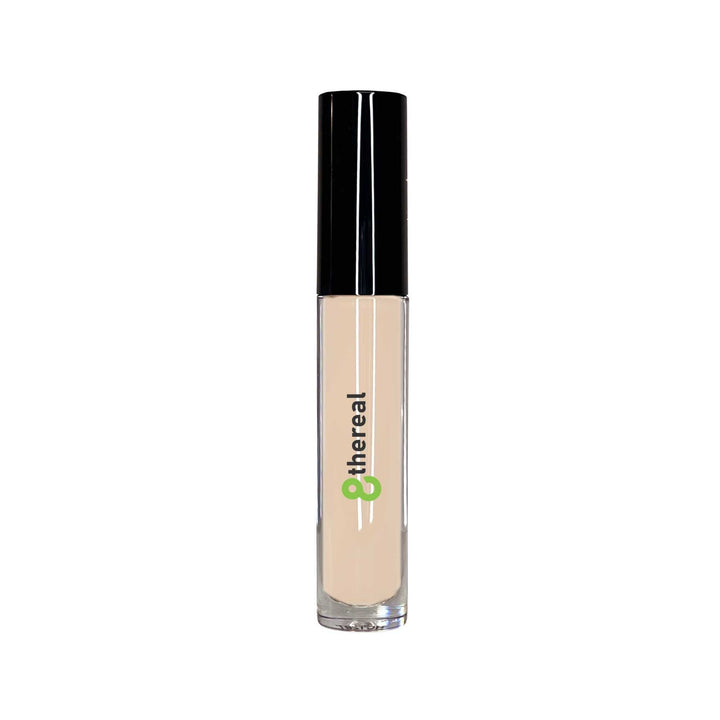 8thereal cream concealer in a clear tube with a black cap, featuring a doe-foot applicator for targeted coverage.