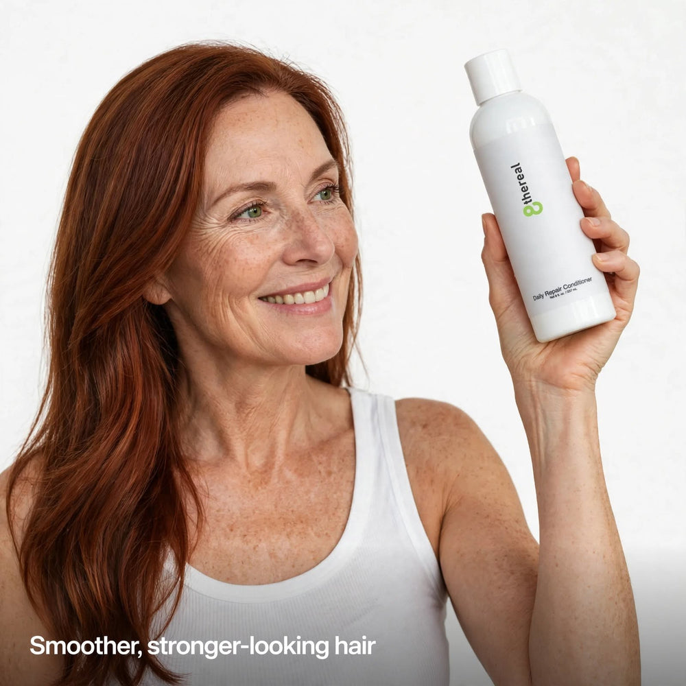 A woman with long auburn hair holding an 8thereal Daily Strengthening Repair Conditioner bottle.