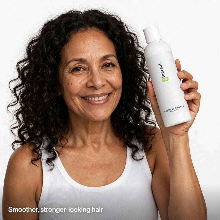 A smiling woman holding an 8thereal Daily Strengthening Repair Conditioner bottle against a white background.