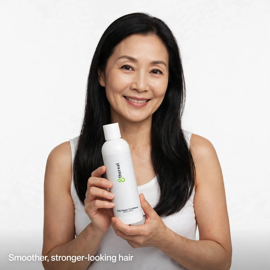A smiling woman holding an 8thereal Daily Strengthening Repair Conditioner bottle against a white background.