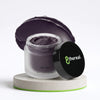 8thereal Deep-Cleansing Glow Mask in a frosted jar with a dark charcoal cream texture on a stone pedestal.