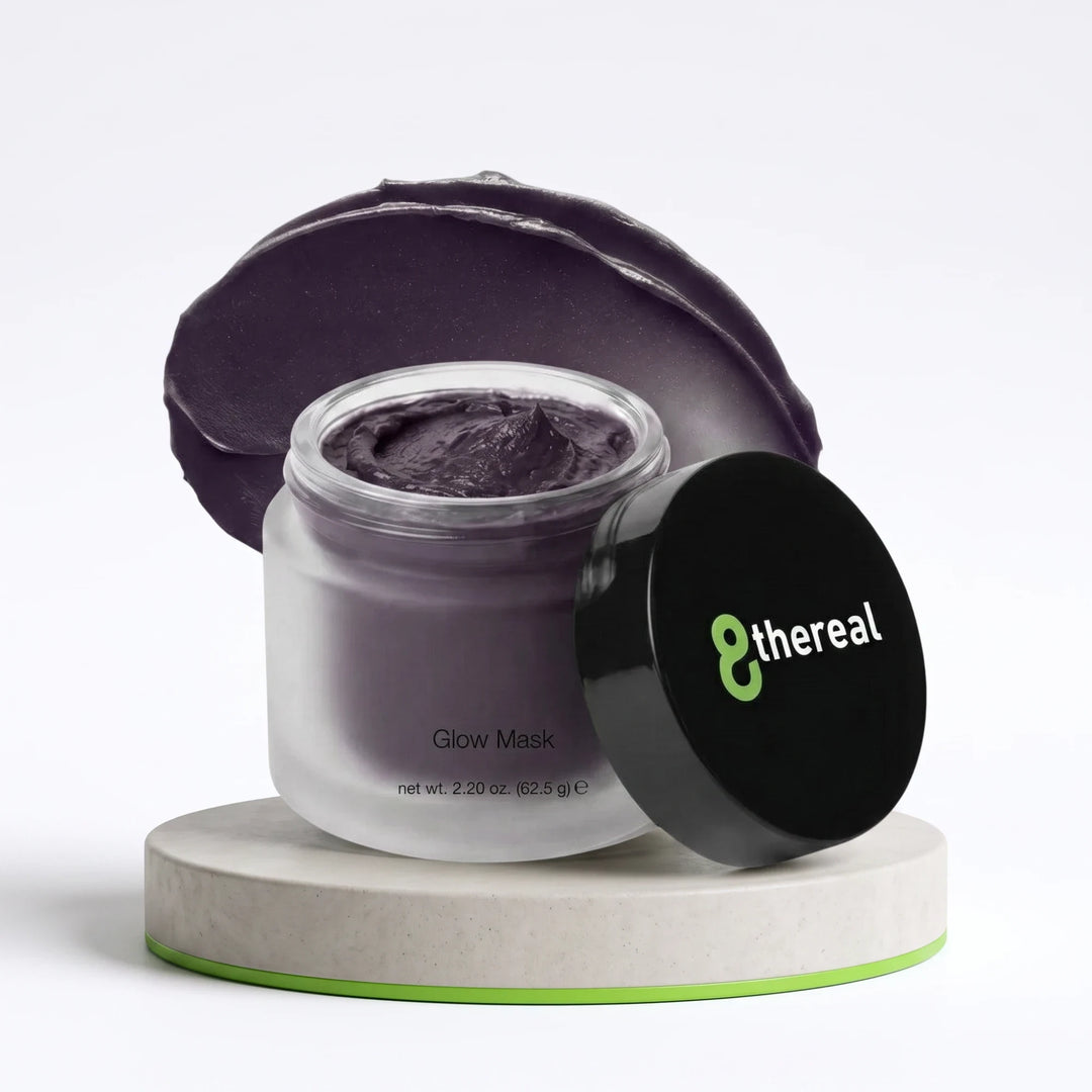 8thereal Deep-Cleansing Glow Mask in a frosted jar with a dark charcoal cream texture on a stone pedestal.