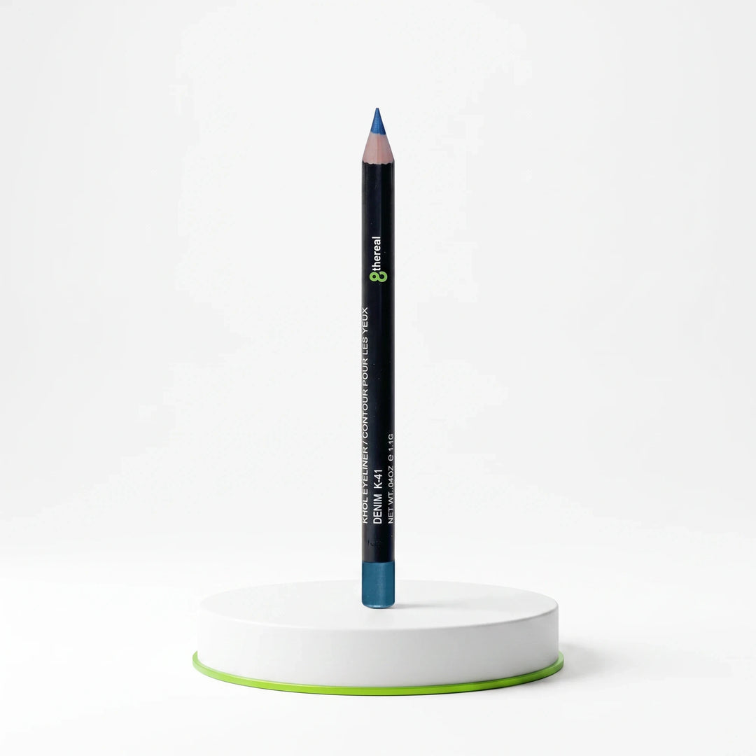 8thereal Soft-Define Khol Eyeliner in Denim blue shade, standing upright on a white circular display base.