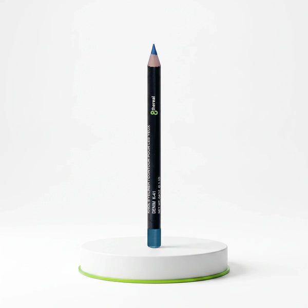 8thereal Soft-Define Khol Eyeliner in Denim blue shade, standing upright on a white circular display base.