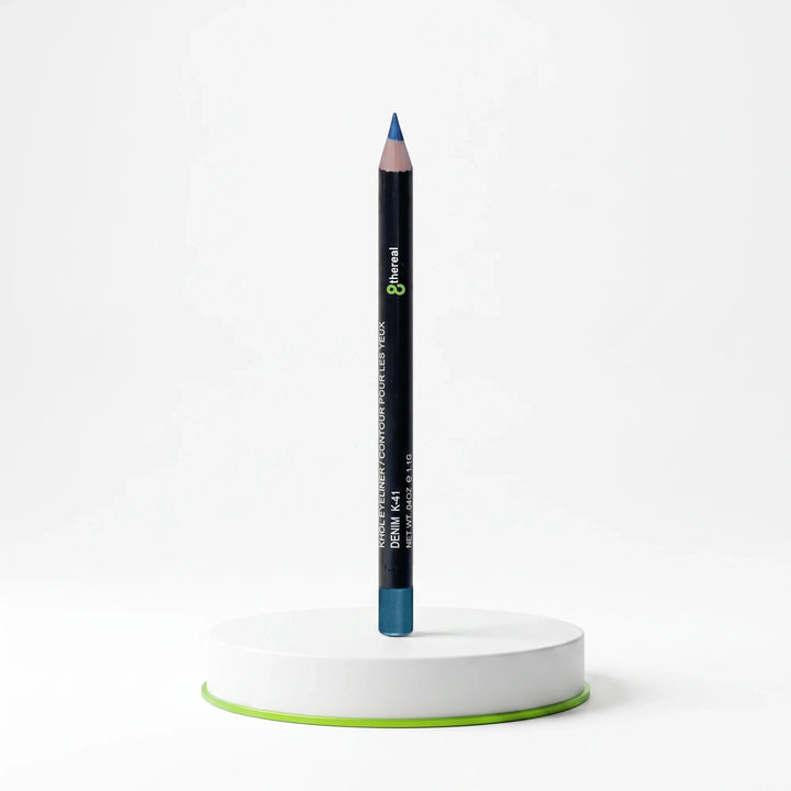 8thereal Soft-Define Khol Eyeliner in Denim blue shade, standing upright on a white circular display base.