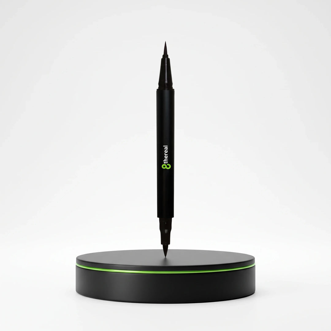 8thereal dual tip eye definer pen in jet-black standing vertically on a circular black base with green trim.