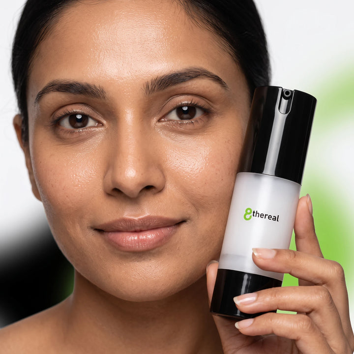 8thereal Extreme Moisture Blend face cream in a pump bottle held by a woman with glowing, hydrated skin.