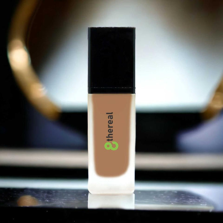 8thereal All-Day Wear Foundation SPF in a sleek glass bottle with a black cap, offering buildable coverage.