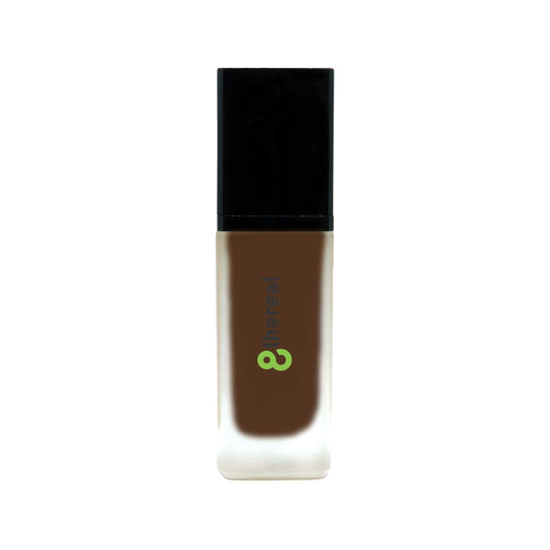 8thereal All-Day Wear Foundation SPF in a sleek glass bottle with a black cap, providing buildable coverage.