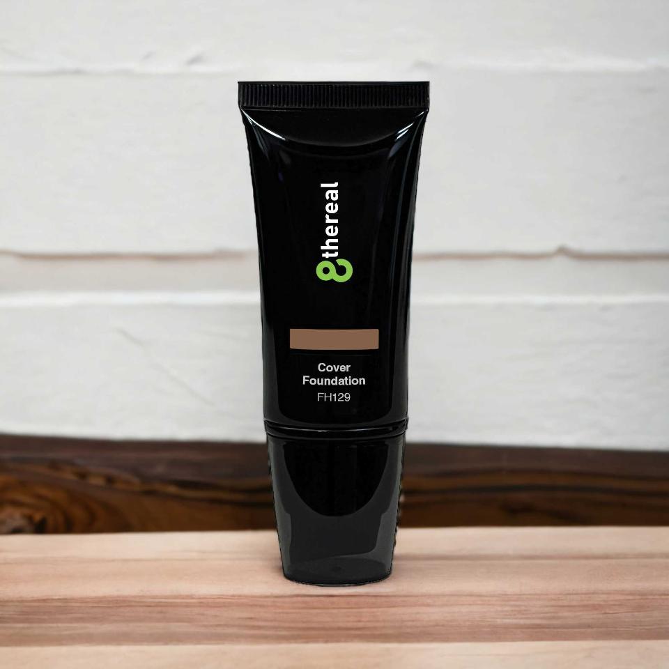 8thereal Skin-First full coverage foundation in a sleek black squeeze tube on a wooden surface.