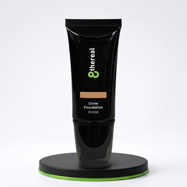 8thereal Skin-First full coverage foundation in a sleek black squeeze tube on a circular display stand.
