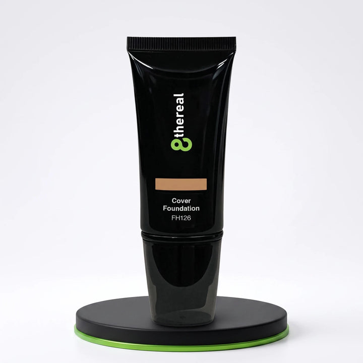 8thereal Skin-First full coverage foundation in a sleek black squeeze tube on a circular display stand.