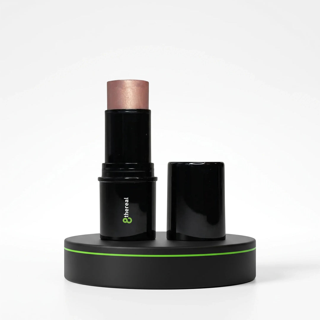 8thereal glow-enhancing highlight stick in a creamy, shimmering rose-gold shade with black twist-up packaging.