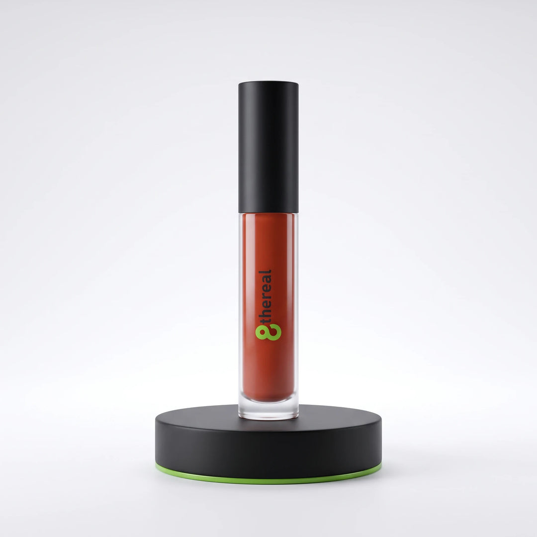 8thereal high-shine lip gloss in a terracotta shade with a black cap, displayed upright on a black circular stand.