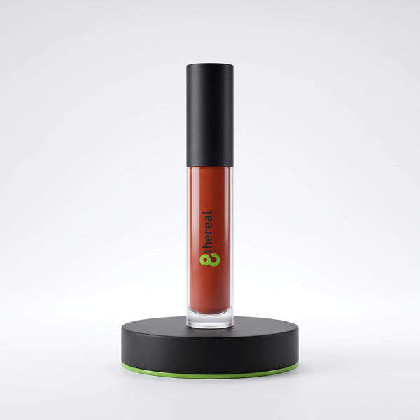 8thereal high-shine lip gloss in a terracotta shade with a black cap, displayed upright on a black circular stand.