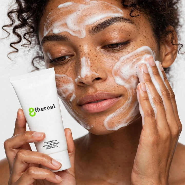 8thereal Hydrating Facial Cleanser applied as a soft lather on a woman's face for gentle, moisture-retaining cleansing.