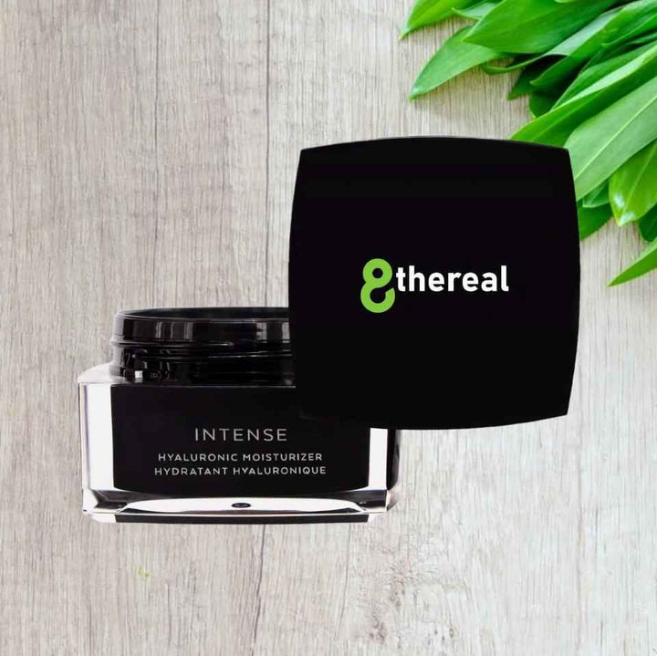 8thereal Intense Hyaluronic Moisturizer in a black jar with a lid, set on a light wood surface with green leaves.