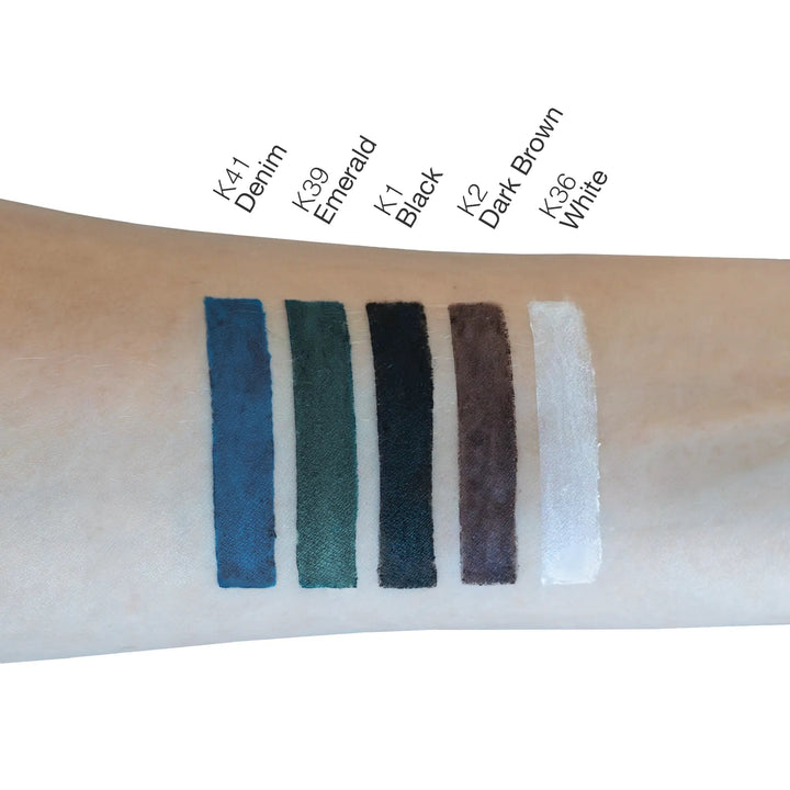 8thereal Soft-Define Khol Eyeliner swatches in Denim, Emerald, Black, Dark Brown, and White on a fair skin tone arm.