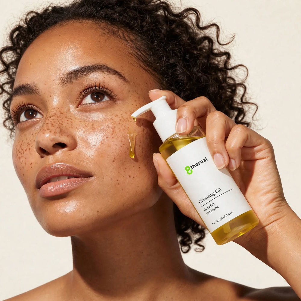 8thereal lightweight cleansing oil being applied by a woman with natural skin, showing the silky golden texture.