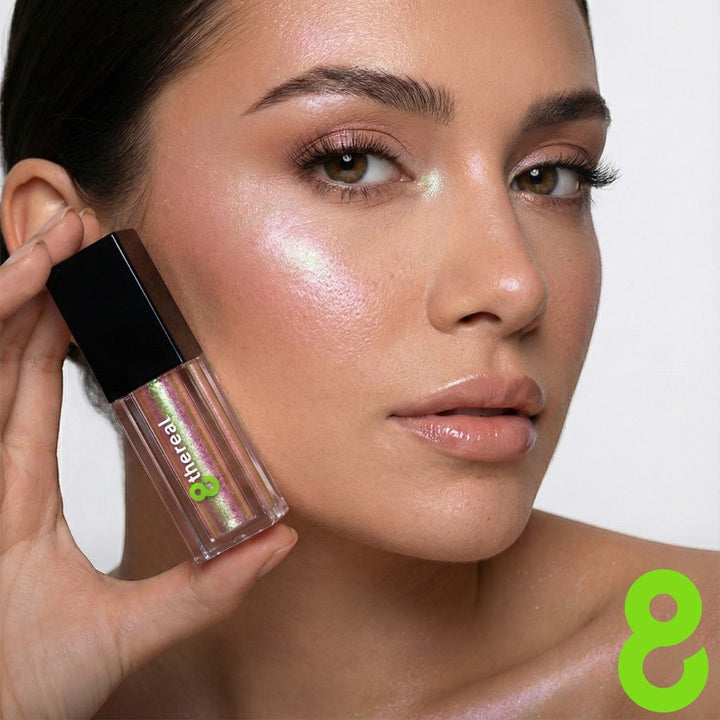 8thereal Liquid Radiance Shimmer applied as a luminous highlight on a model's cheekbone with a wet-look finish.