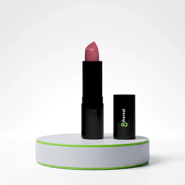 8thereal luxury cream lipstick in a soft pink shade with a satin finish, displayed on a white pedestal.