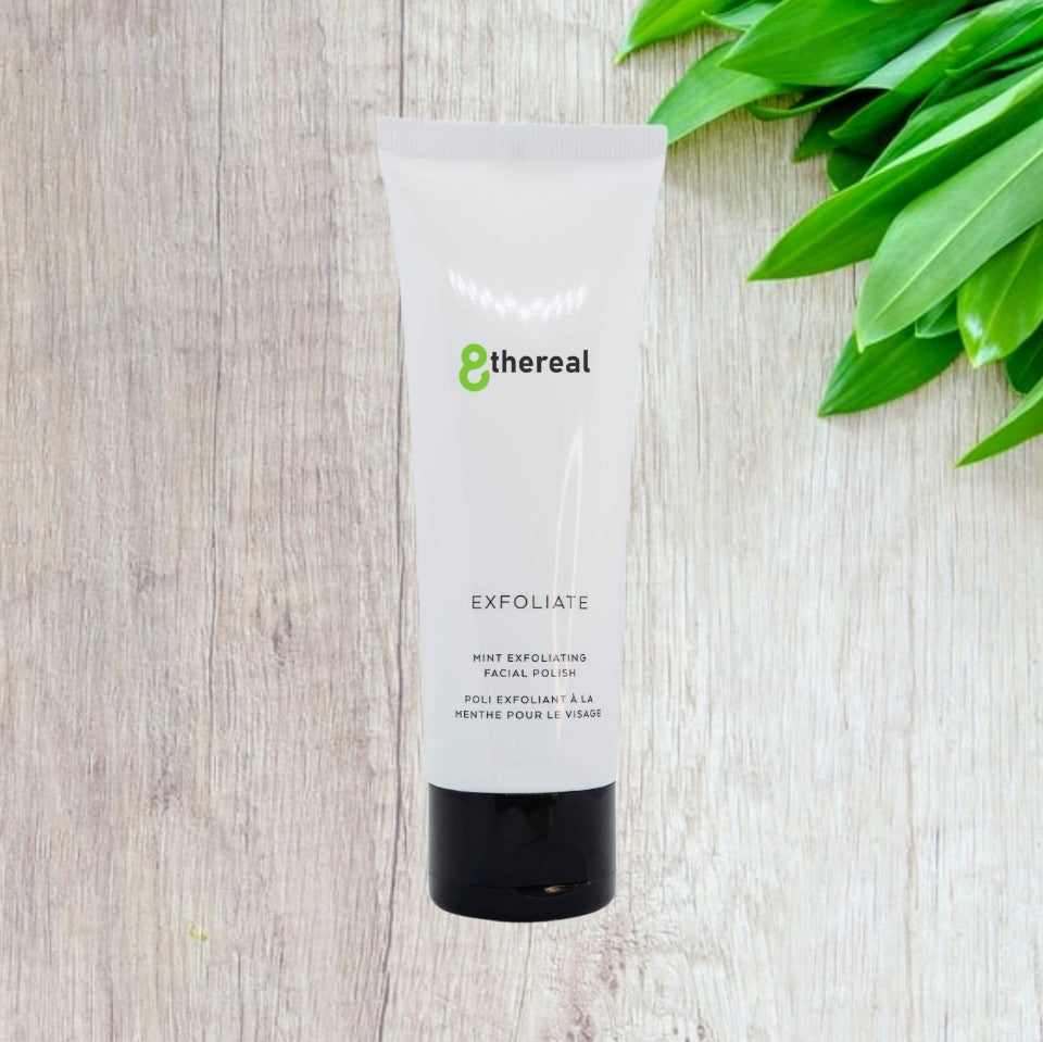 8thereal Gentle Refining Facial Polish in a white squeeze tube with a black cap, set against a light wood background.