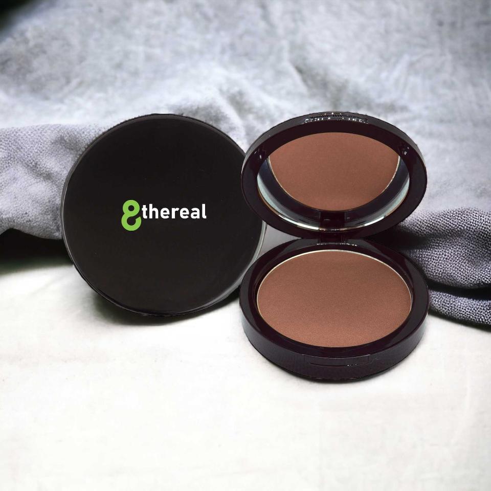 8thereal Natural Warmth Bronzer in a sleek dark compact with mirror, featuring silky, buildable pressed powder.