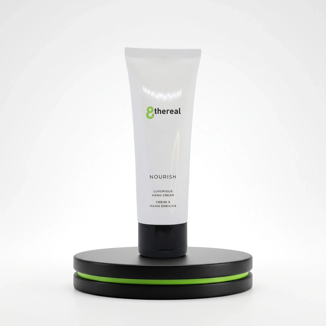 8thereal Restorative Nourish Hand Cream in a white squeeze tube with black cap, displayed on a black and green pedestal.