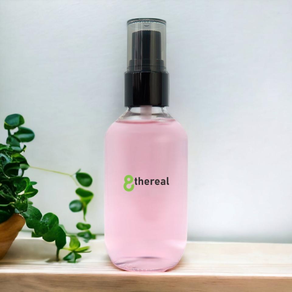 8thereal oil control setting spray in a clear bottle with pink liquid, featuring a black pump and minimalist label.