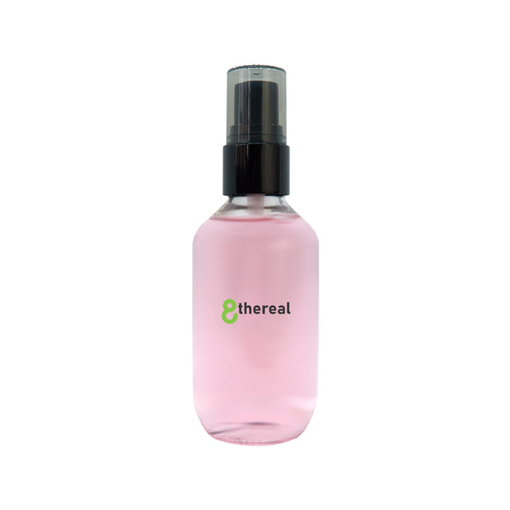 8thereal oil control setting spray in a clear bottle with a black pump, featuring a light pink liquid formula.