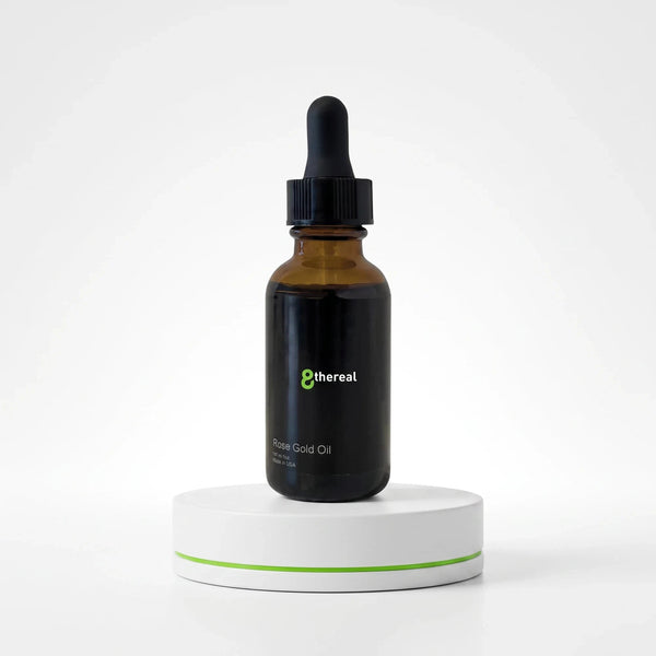8thereal Rose Gold Facial Oil in a dark glass dropper bottle on a white pedestal for dry, dull skin nourishment.