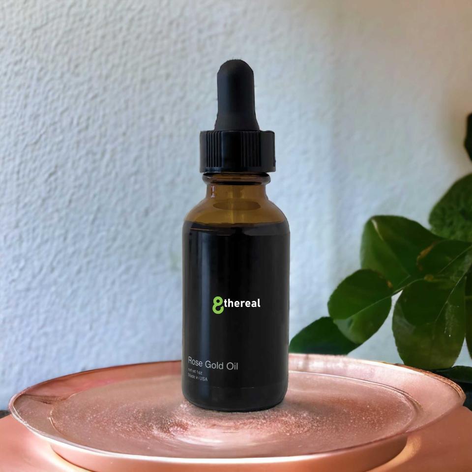 8thereal Anti-Aging Rose Gold Facial Oil in a dark glass dropper bottle resting on a metallic rose gold tray.
