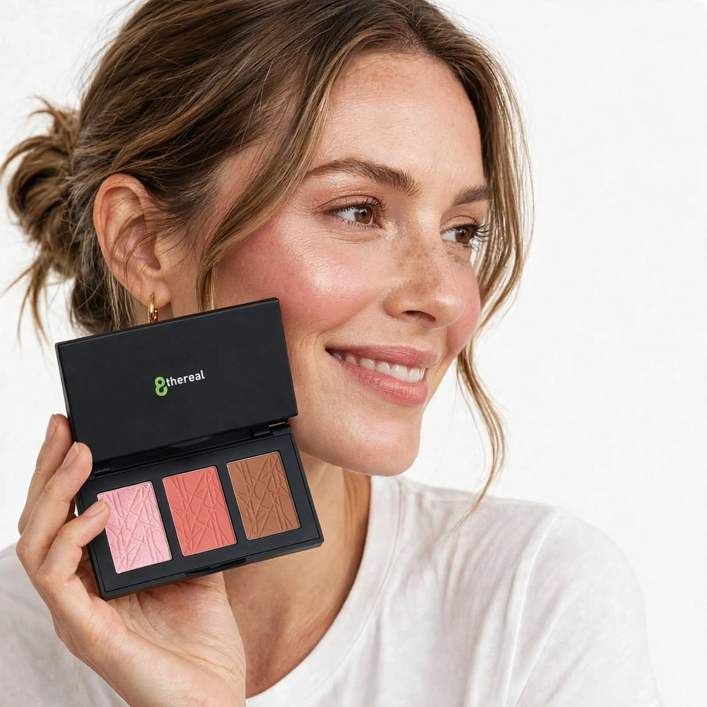 Model holding 8thereal All-in-One Sculpt & Glow Pro Cheek Palette featuring blush, contour, and highlighter powders.