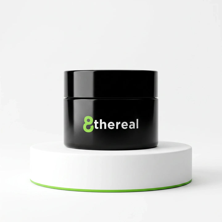 8thereal Smoothing Ageless Eye Cream in a sleek black jar displayed on a white circular pedestal against a white background.