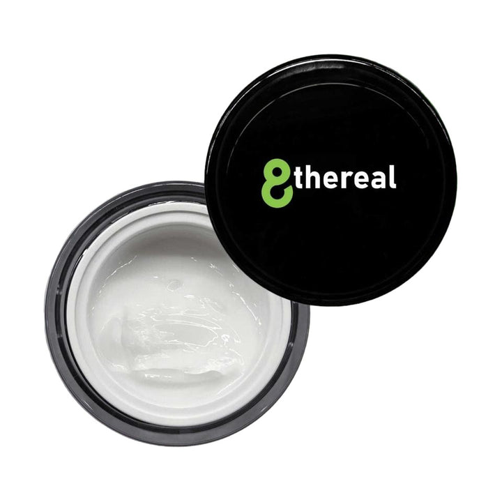 8thereal Smoothing Ageless Eye Cream in an open jar with a black lid, showing the silky white hydrating formula.