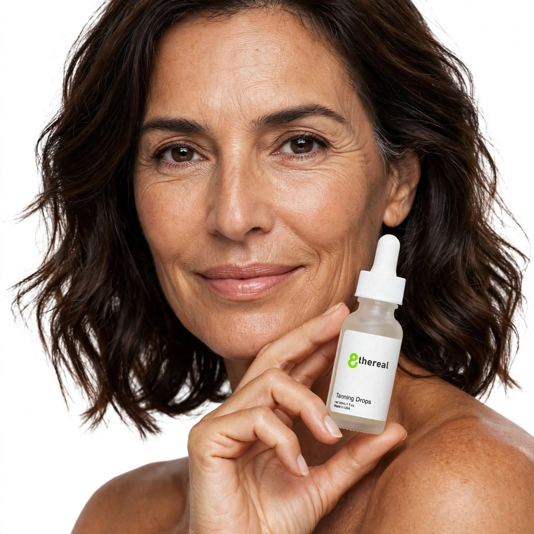 A smiling woman holding a bottle of 8thereal Sunlit Glow Tanning Drops, a lightweight serum for a natural tan.