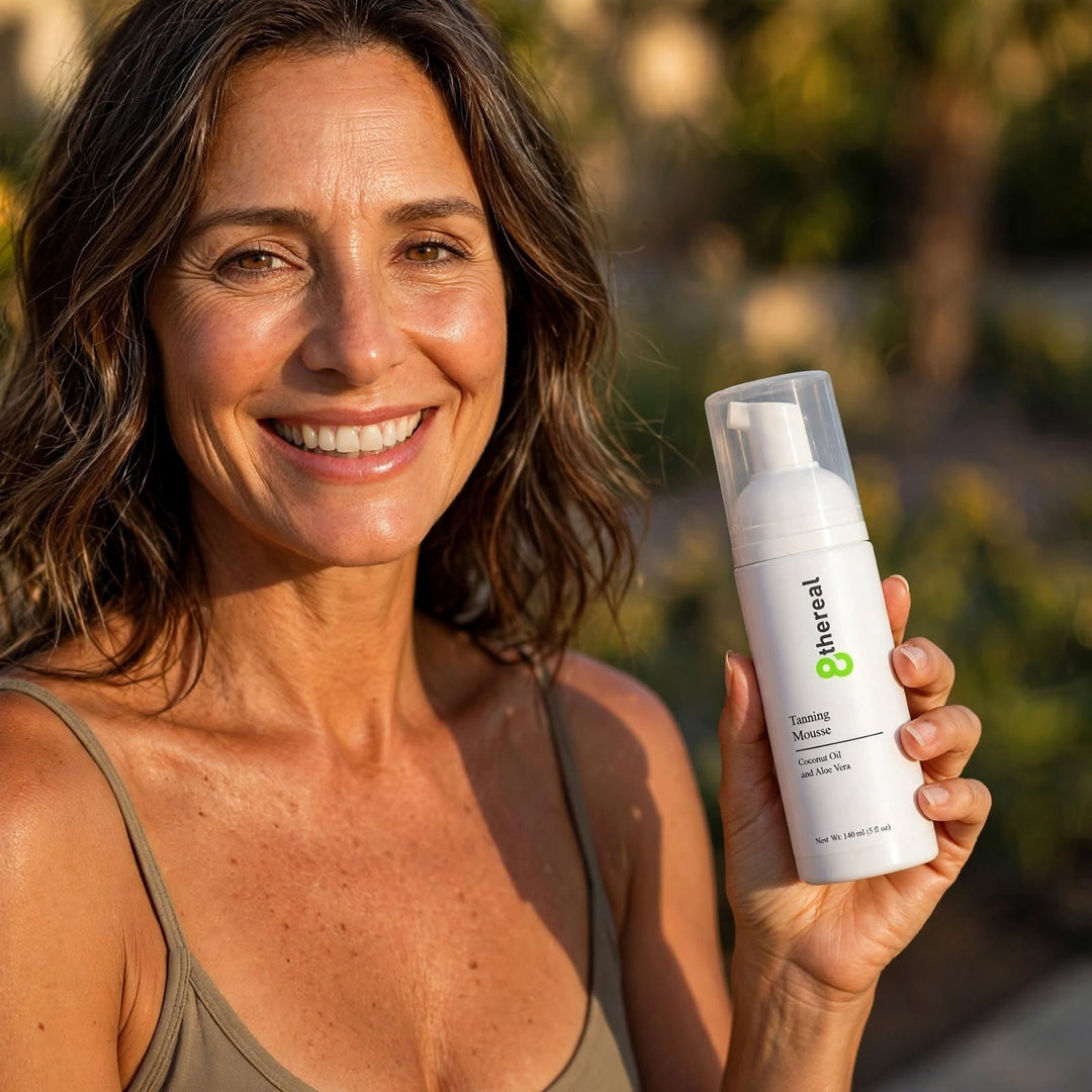 A smiling woman holding an 8thereal Tanning Mousse bottle outdoors, showcasing a natural sun-kissed glow.